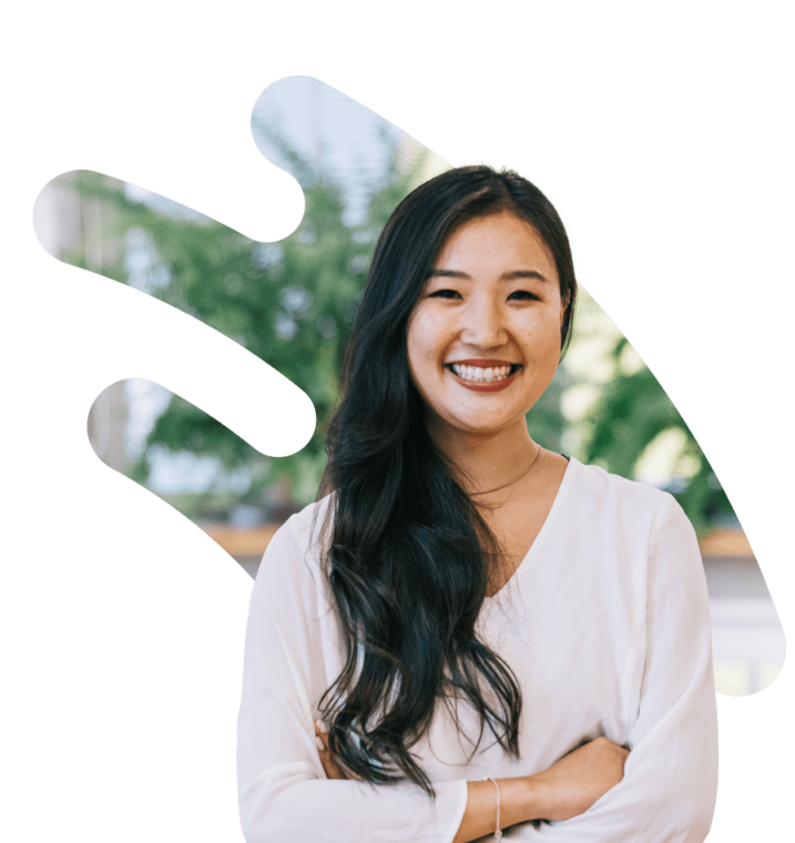 A woman in front of an outdoor scene with greenery in a cut-out image.