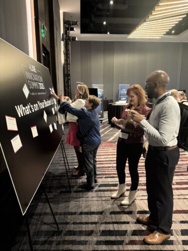 Senior living professionals adding to the Dream Wall at the 2025 Aline Innovation Summit.