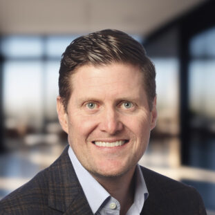 Brandon Logsdon, the CEO of Aline, against a blurred-out office space in the background.
